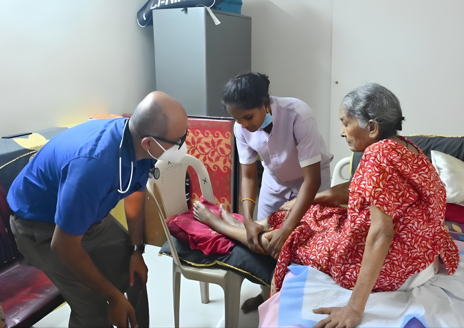 A caregiver helping a senior with groceries in their kitchen.