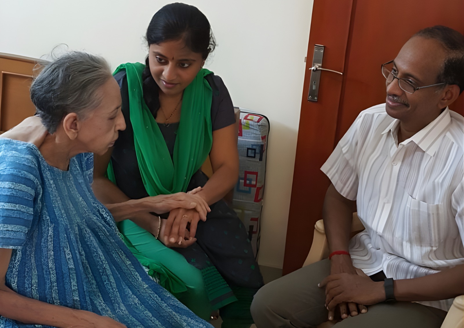 A nurse checking a patient's vitals at home.